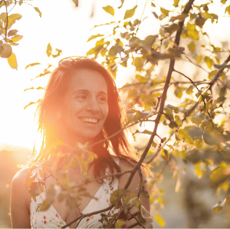 happy woman in sunset glow trees